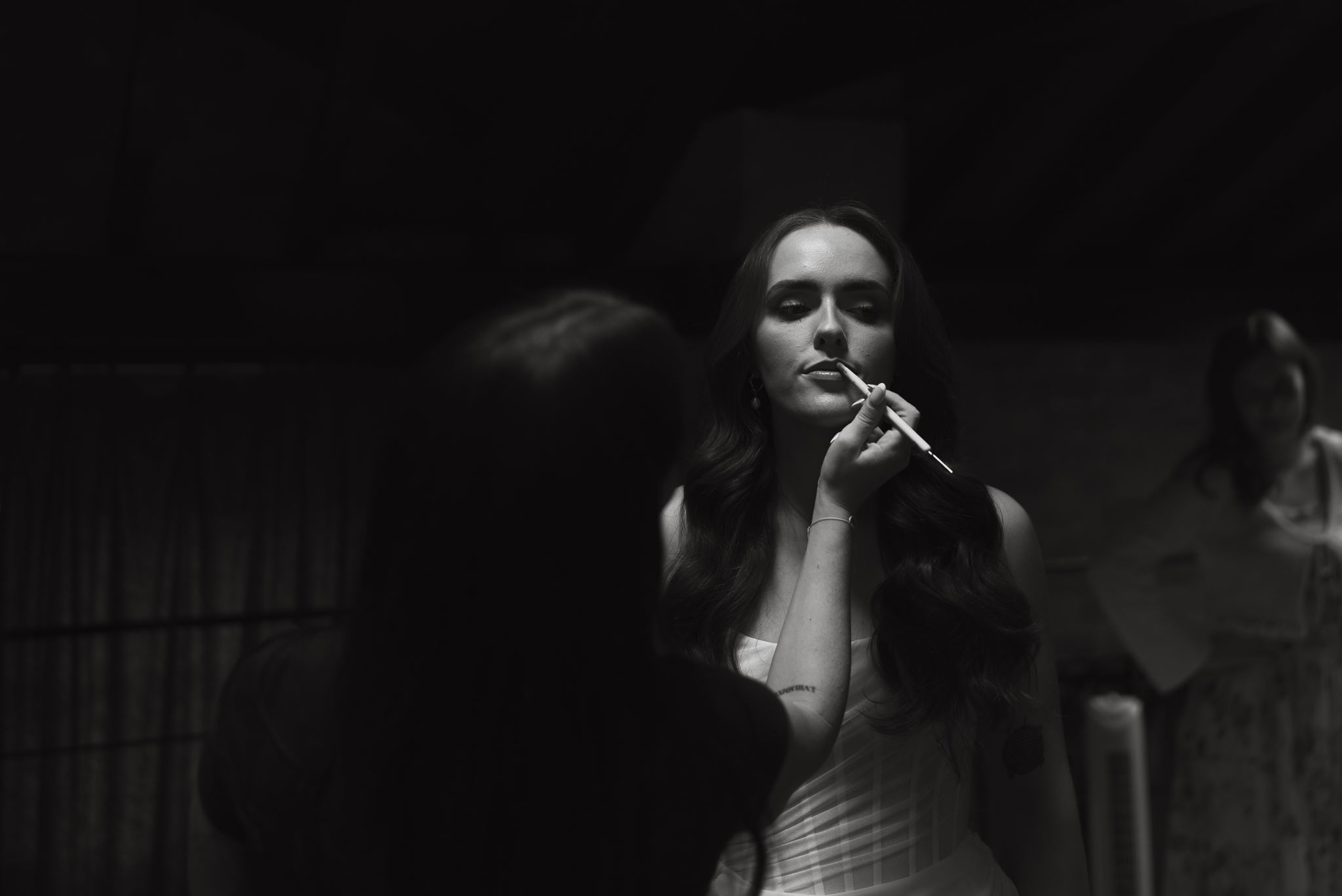 Bride having makeup applied on the morning of the wedding