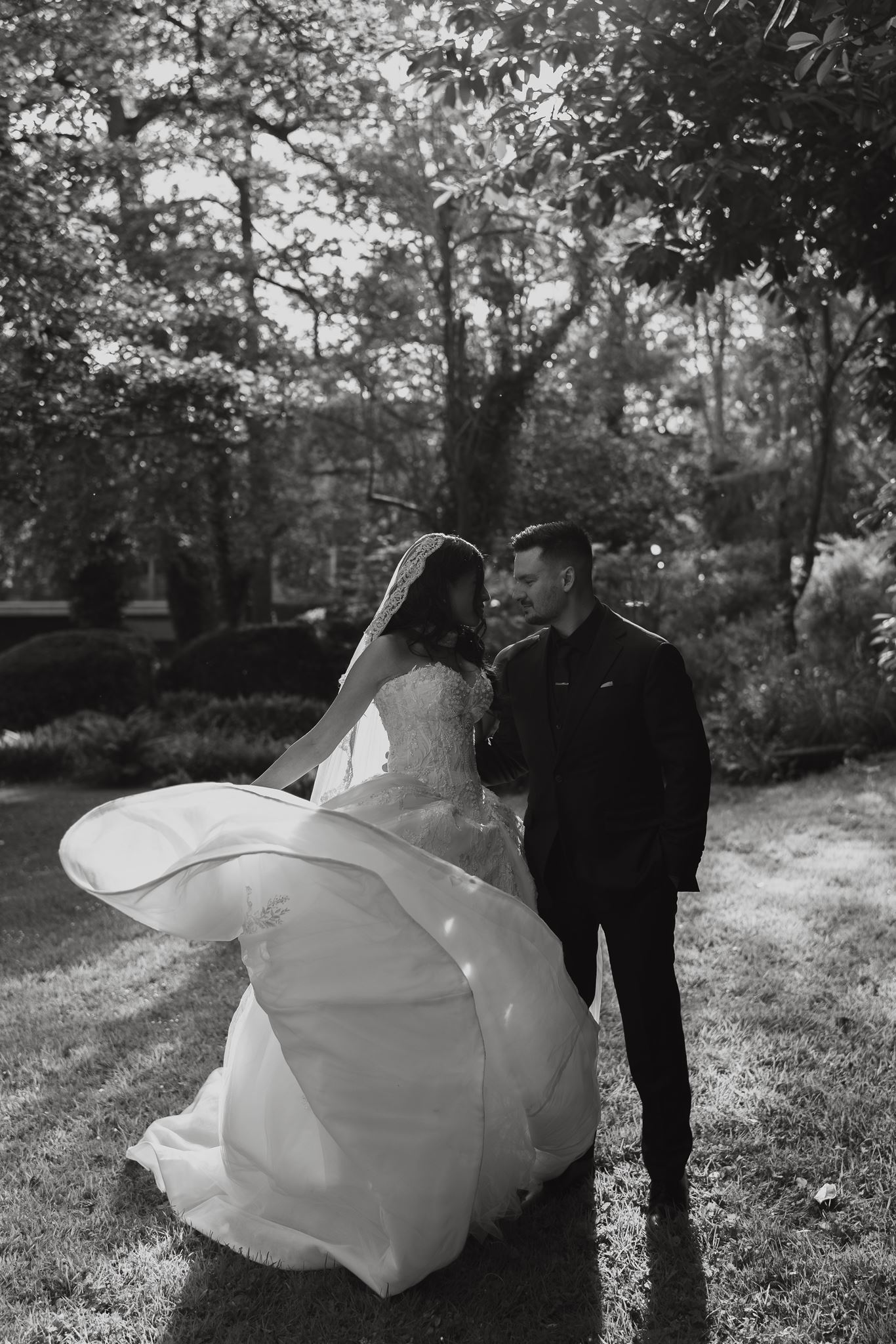 Bride turning, veil and dress catching the light